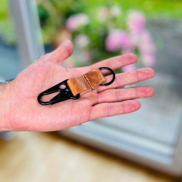 taktischerer Karabiner in der Farbe Schwarz mit hellbraunem Leder.